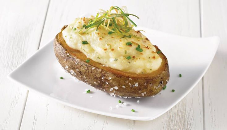 a piece of bread topped with mashed potatoes and garnished with chives