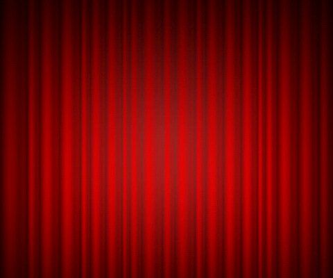 a red curtain with the light shining on it