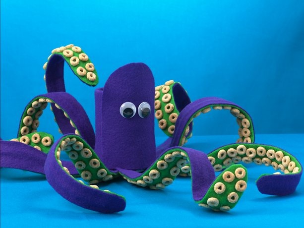 an octopus stuffed animal sitting on top of a blue surface