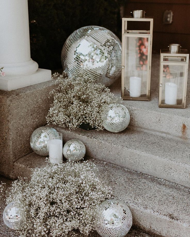 silver ornaments and candles on the steps outside