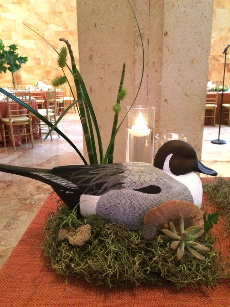 a duck sitting on top of a pile of grass