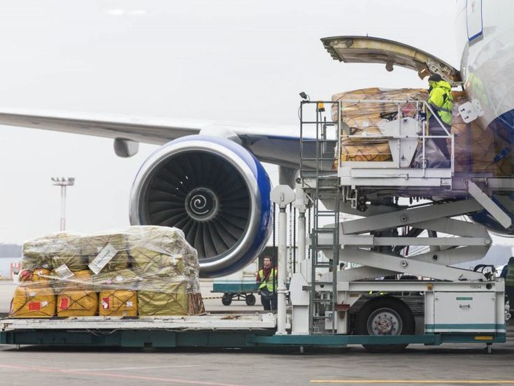 an airplane with luggage being loaded onto the back of it's cargo cart,