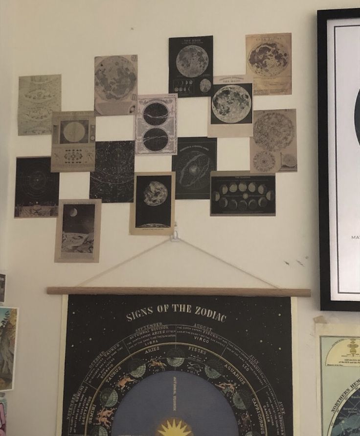 there are many pictures on the wall and one has a clock hanging from it's side