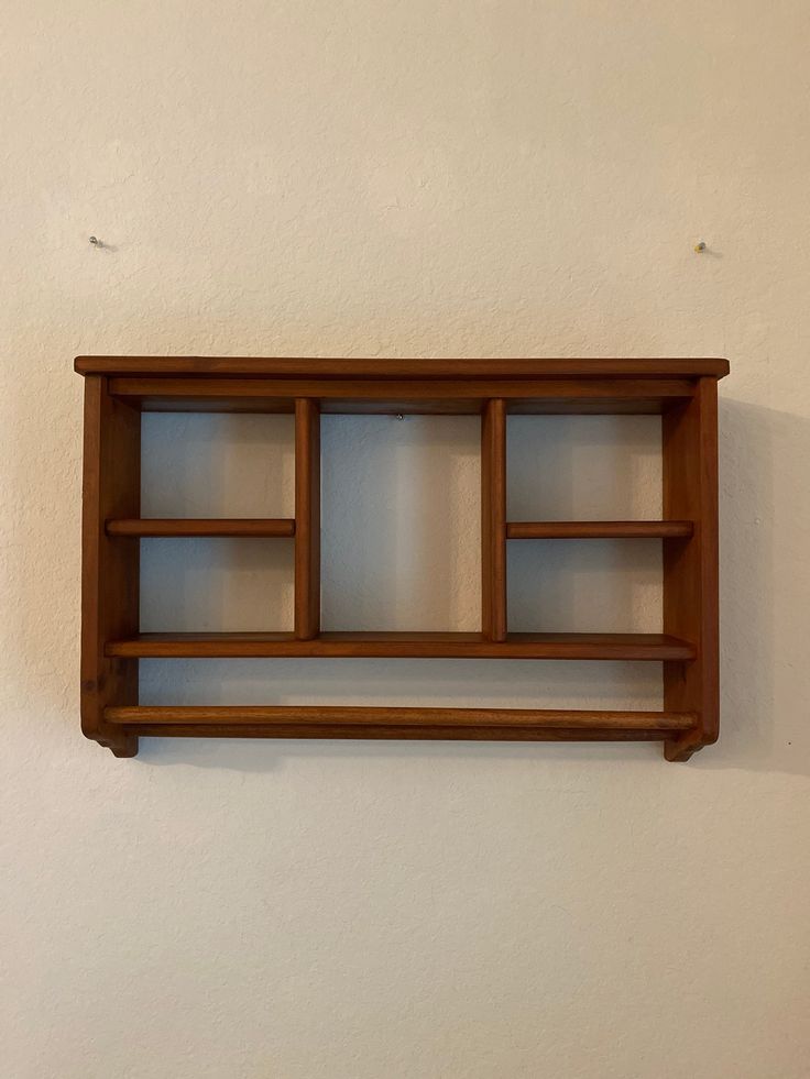 a wooden shelf mounted to the side of a wall