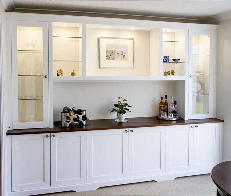 a white cabinet with glass doors and shelves