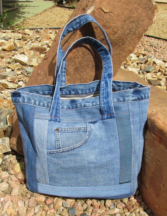 a blue bag sitting on top of a rock next to a stone wall and some rocks