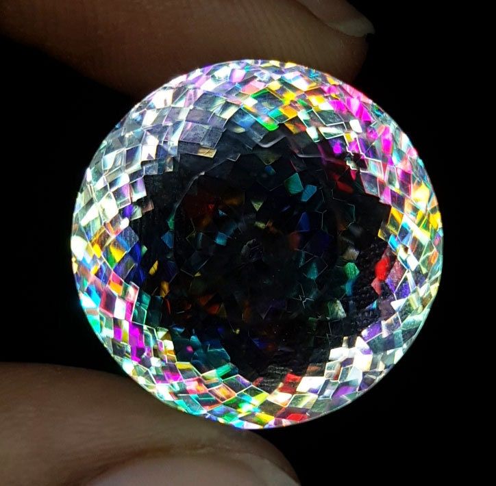 a close up of a person's hand holding a crystal ball