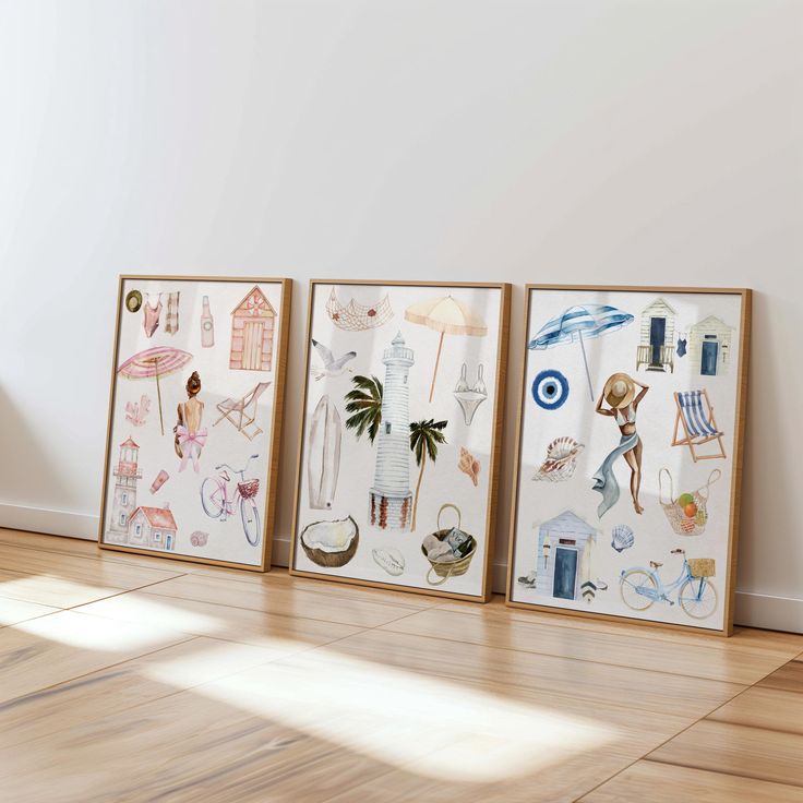 three framed art pieces sitting on top of a hard wood floor