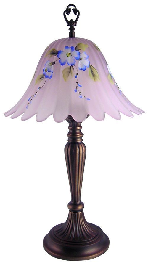 a pink lamp with blue flowers on it