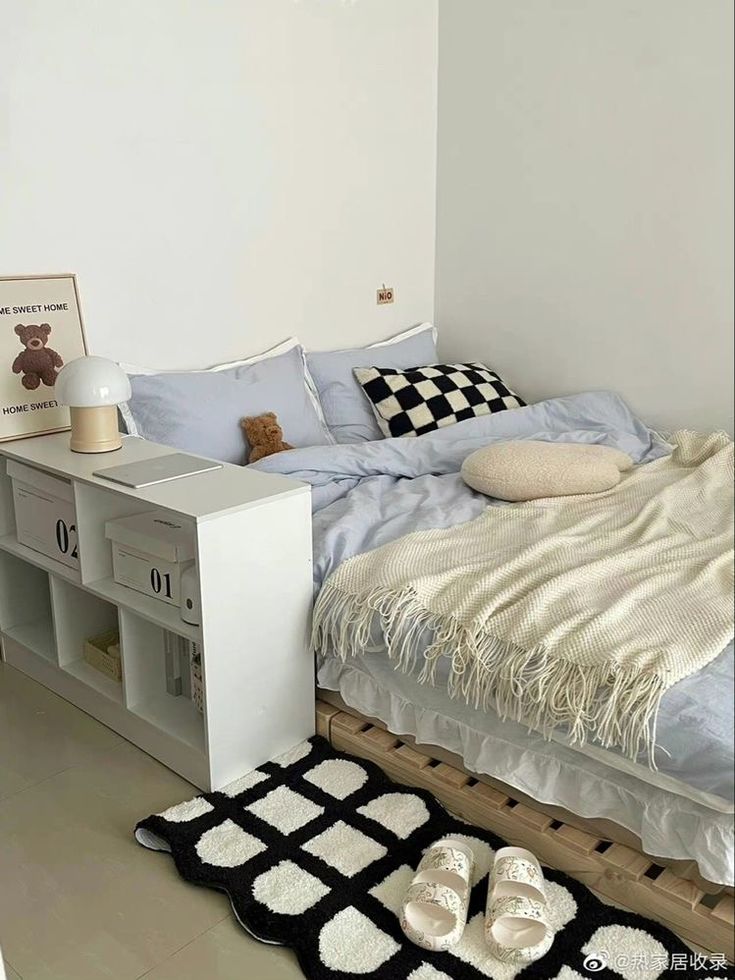 a bedroom with a bed, bookcase and rugs