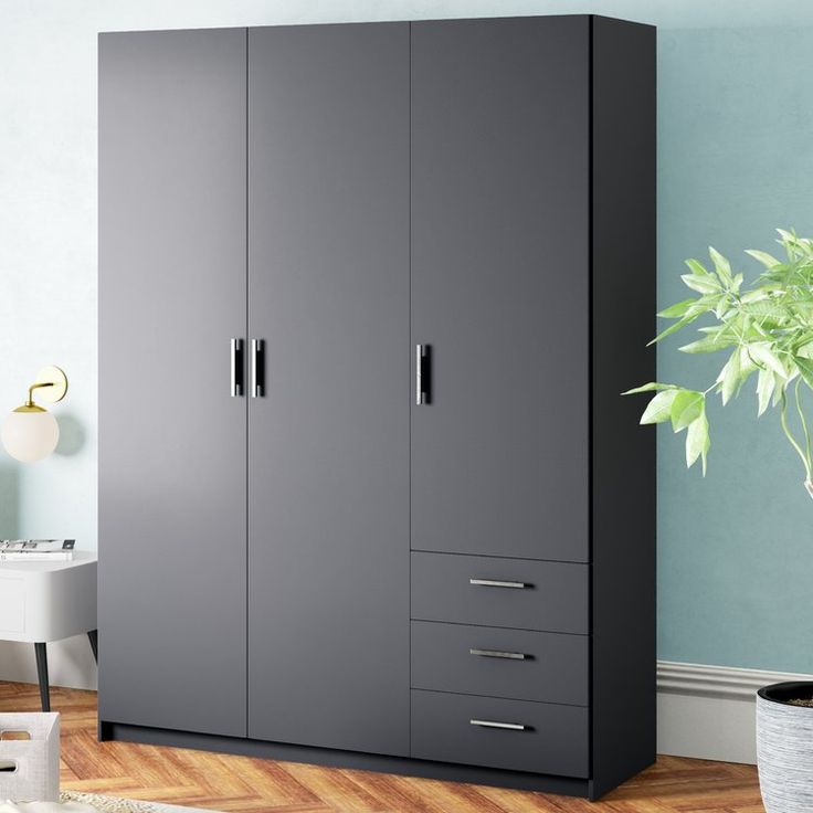 a large gray cabinet with drawers in a living room next to a potted plant