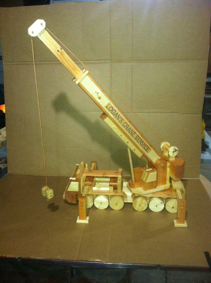 a wooden model of a crane on display