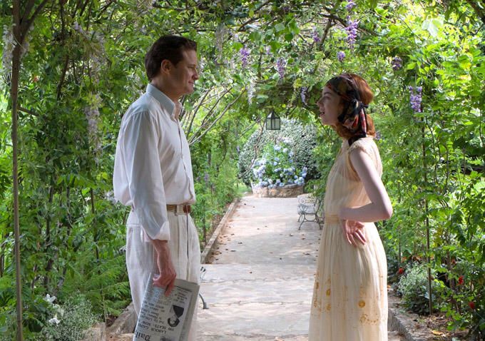 a man and woman standing in the middle of a garden with trees on either side