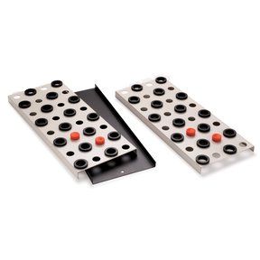 two black and white peg board game pieces on a white surface with red dots in the middle