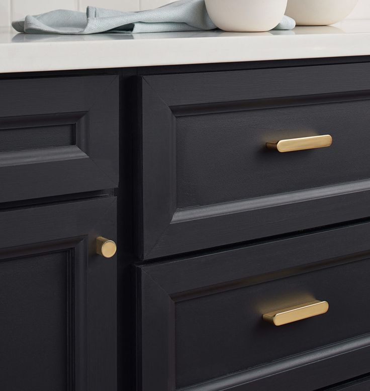 a white bowl sitting on top of a black dresser