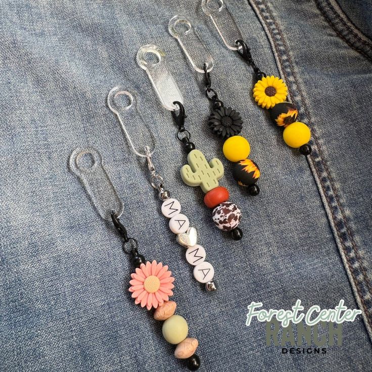 six pairs of cell phones hanging from the back of a jean jacket with charms attached to them