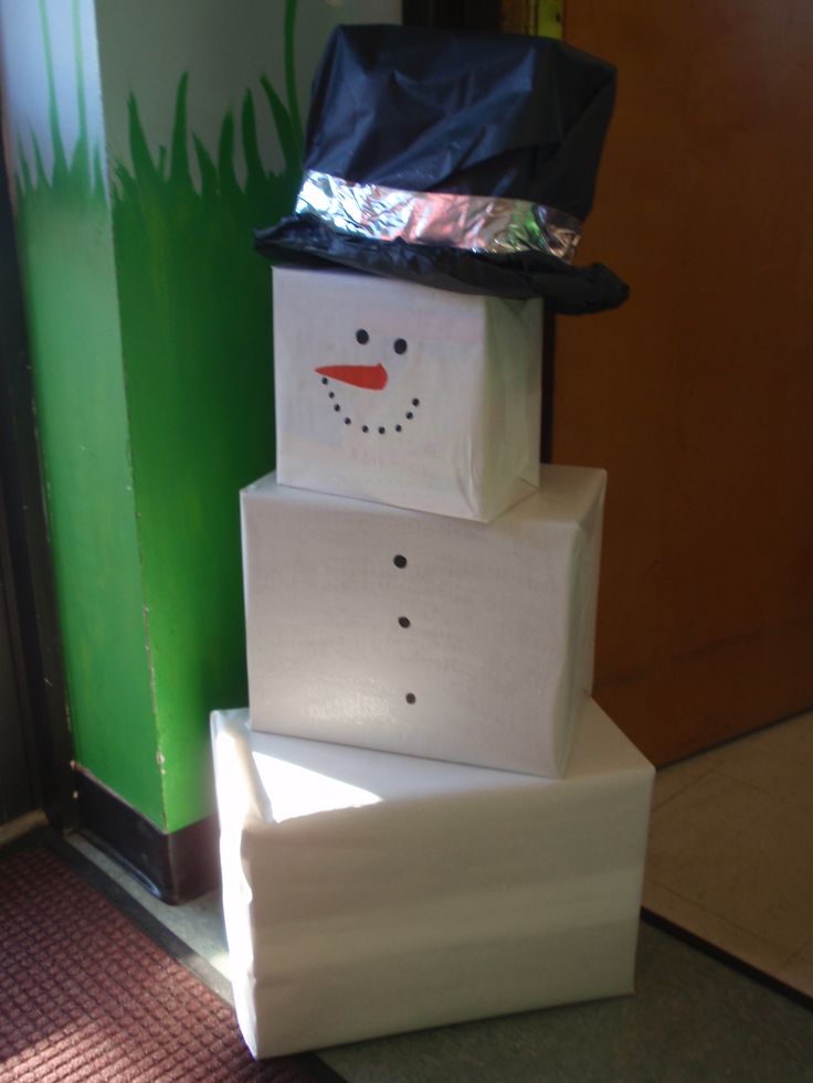 three boxes stacked on top of each other in the shape of a snowman wearing a hat