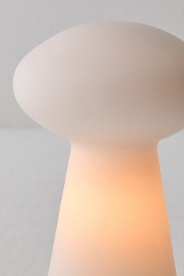 a white table lamp sitting on top of a counter