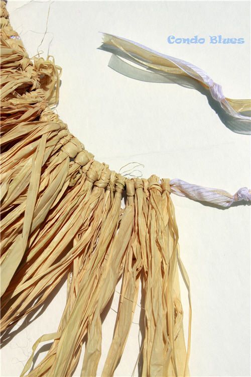 two pieces of woven material are laid out on the floor with strings attached to them