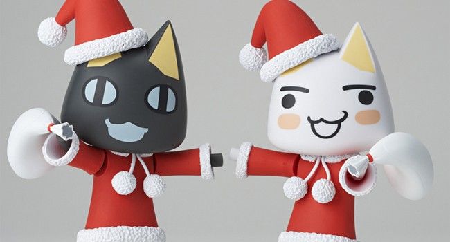 two figurines are dressed up as santa and black cat