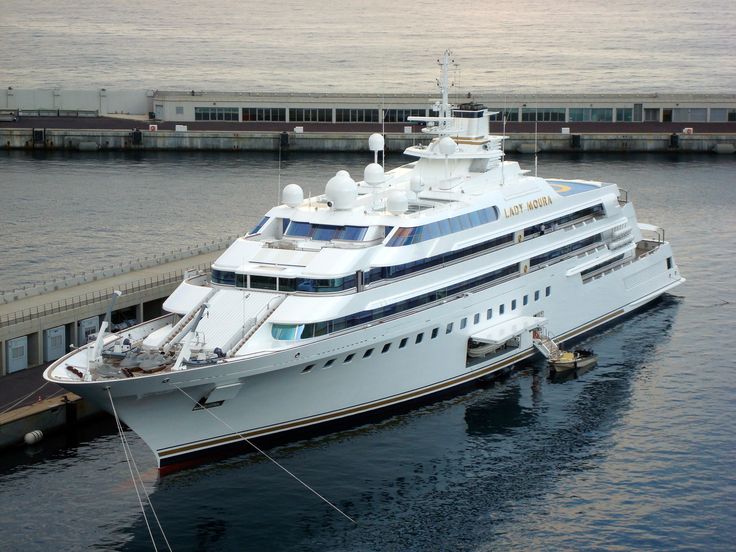 a large white boat in the water next to a dock