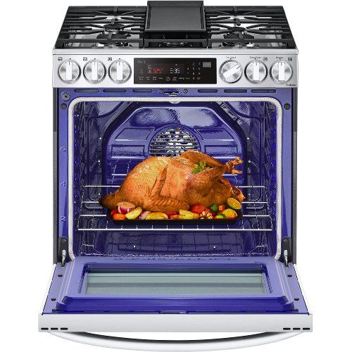 a turkey roasting in an oven with the door open to show it's food