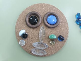 a rock with various stones and beads on it