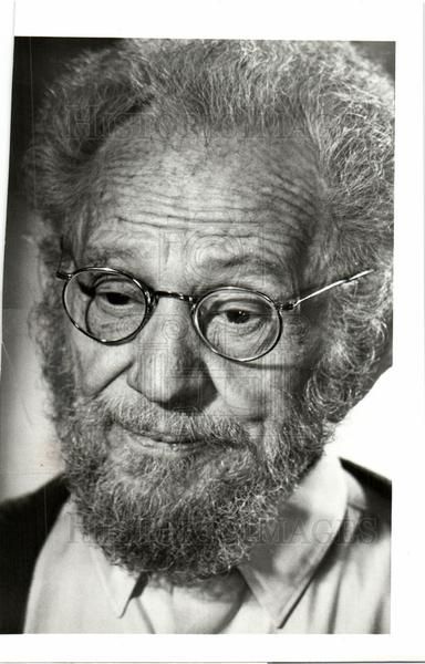 an old black and white photo of a man with glasses