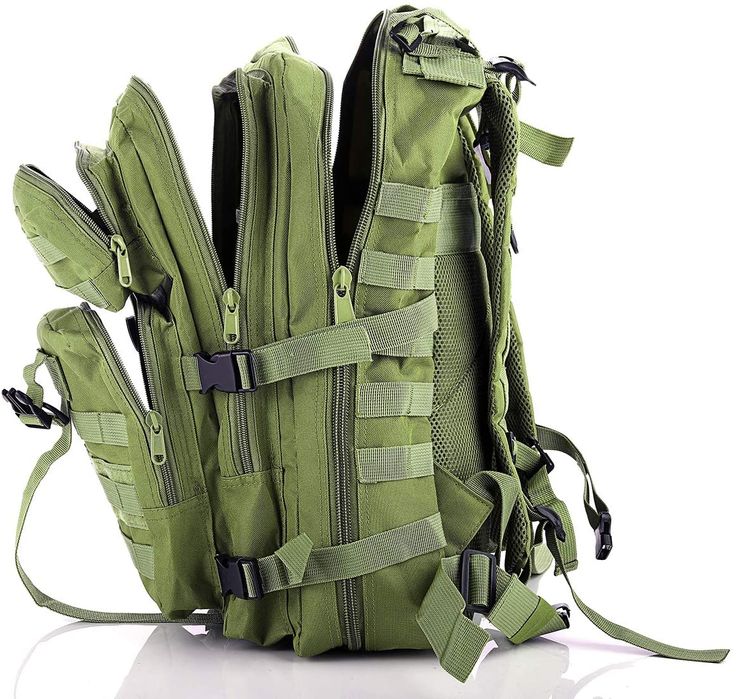 an army green backpack with multiple compartments and straps on the front, sitting against a white background