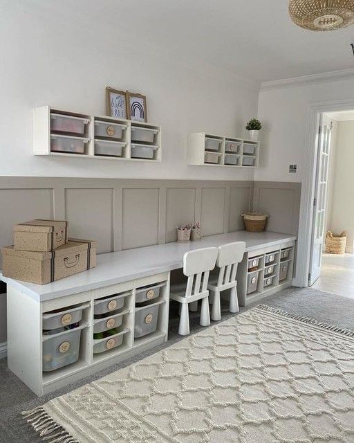 a room filled with lots of white furniture and storage bins on top of it