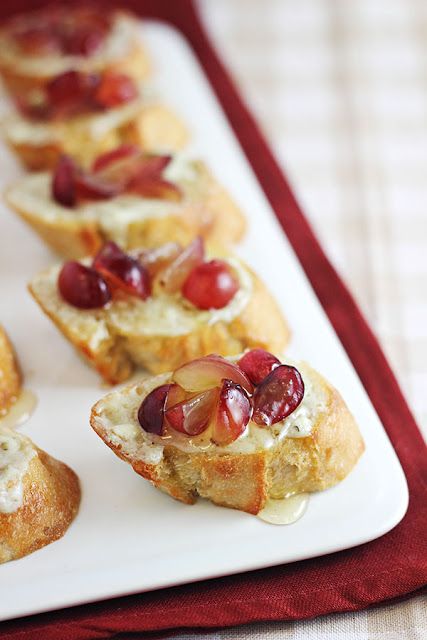 small appetizers are lined up on a white plate