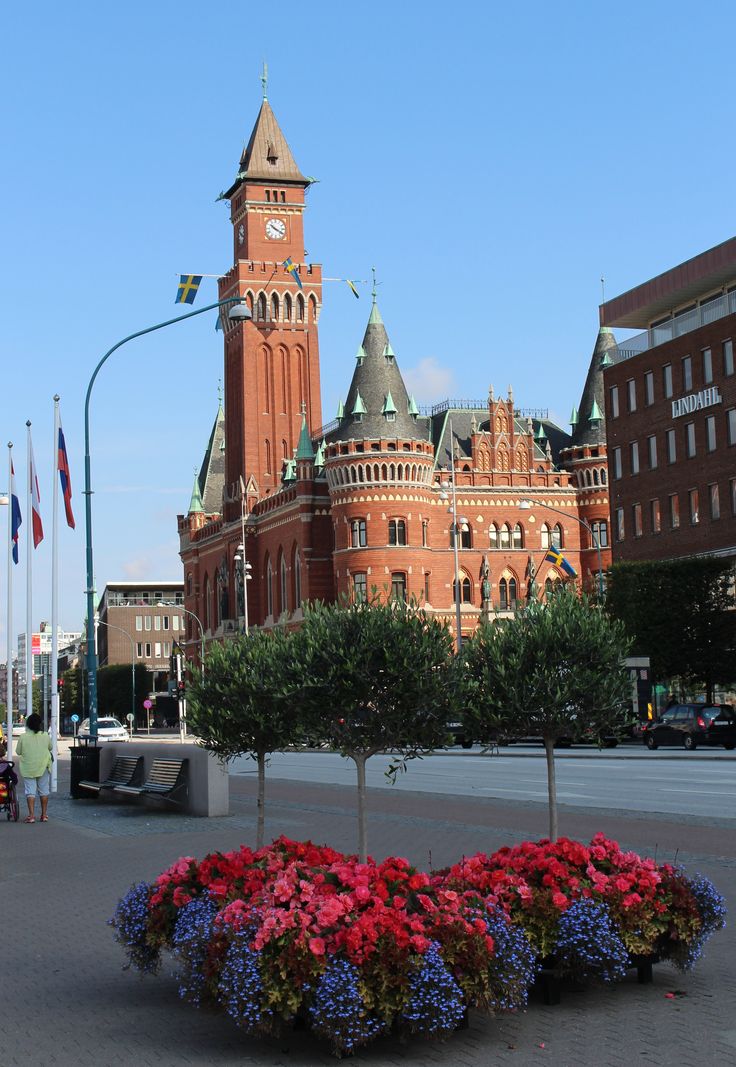 a large building with a clock tower in the middle of it's front yard