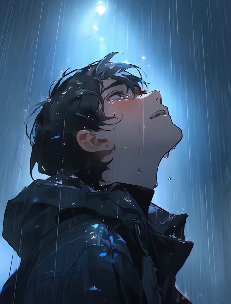 a man standing in the rain with his eyes closed