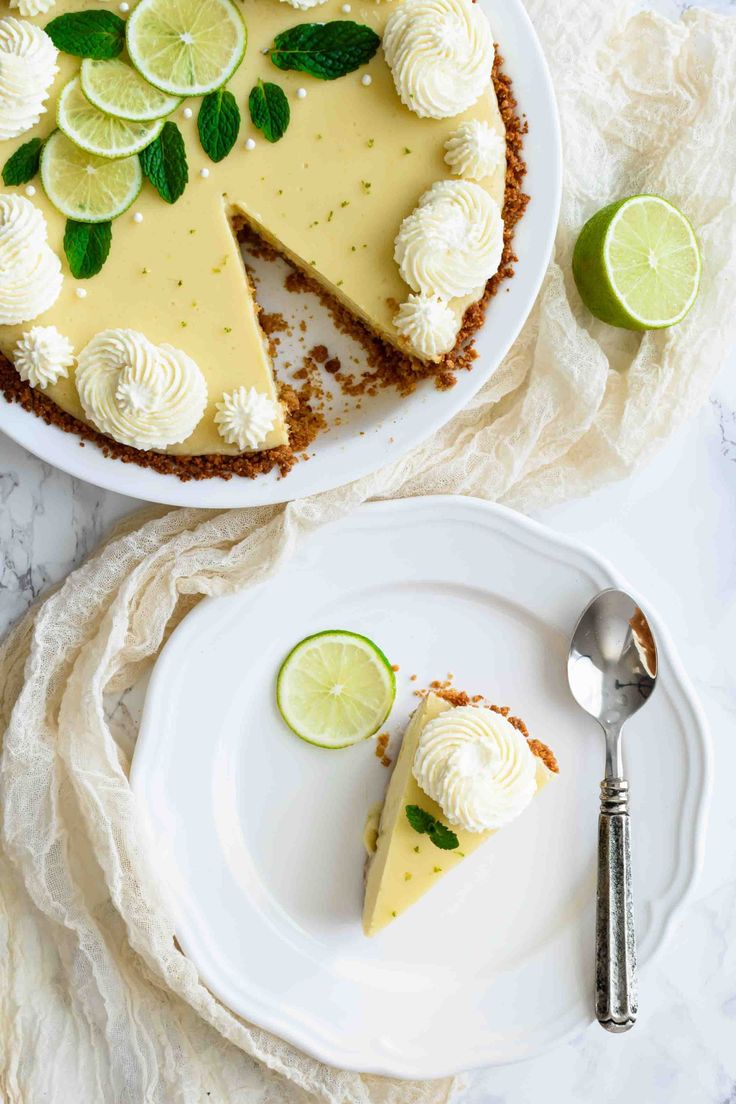 two slices of key lime pie on plates with one slice cut out and the other half eaten