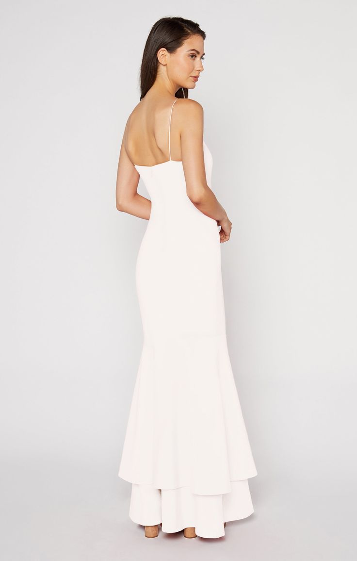 Juxtaposing the simple straight neck and straps, this flowy, double-tiered, mermaid-style gown will make a statement at every formal event.The Aurora Gown in white is a "soft white". Fit Details FittedLinedFit-and-flare silhouetteZipper and button closure on backDouble layer ruffle hem73% Polyester 22% Rayon 5% Spandex Dry Clean Only ImportedMeasurementsLength: 62.75in/159.39cm, from top edgeMeasurements from size 4 White Grad Dress Long, White Graduation Dress Long, Spring Formal Dresses Long, White Formal Dress Long, Kendall Jenner White Dress, Long White Flowy Dress, White Graduation Gown, White Grad Dress, Aurora Gown