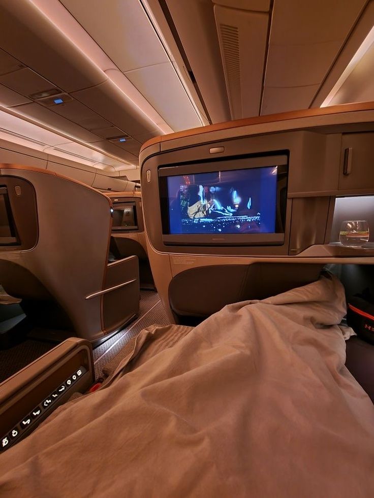 the inside of an airplane with a flat screen tv