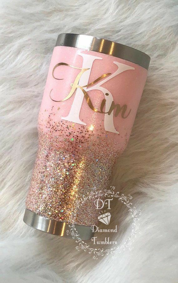 a pink and gold glitter tumbler with the letter k on it's side