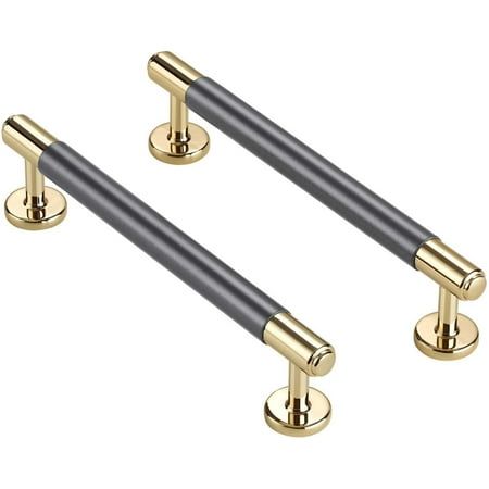 two brass and black door handles on white background