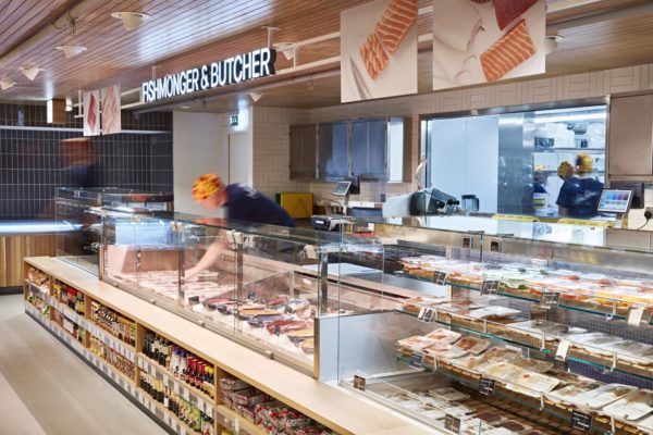 a man is working behind the counter at a deli