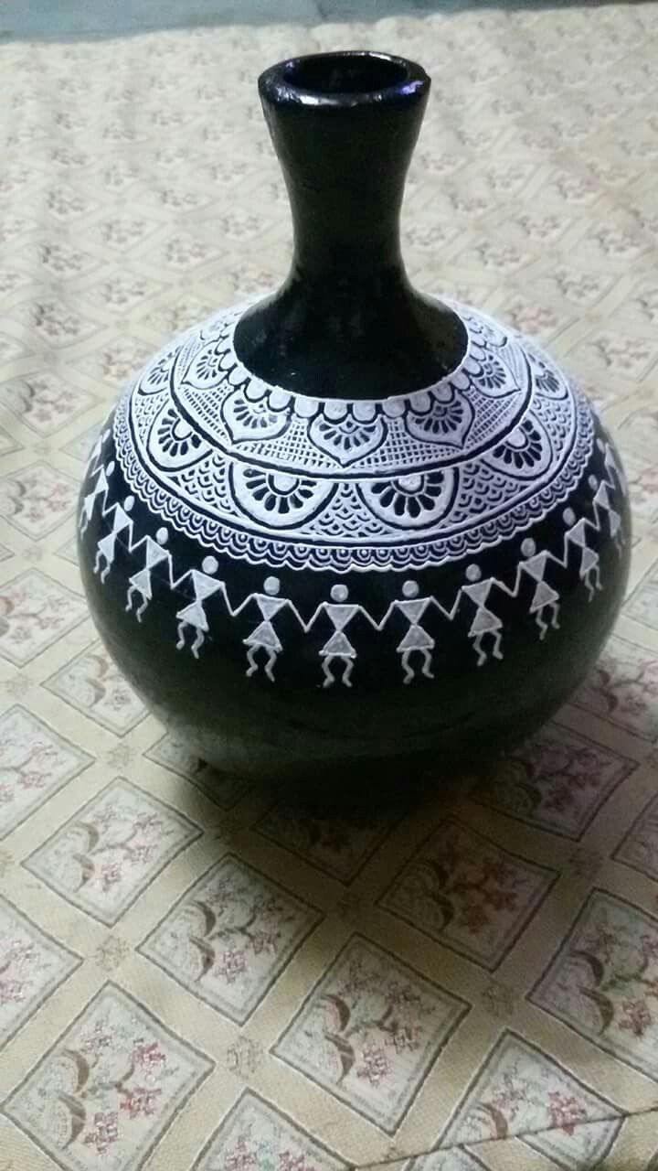 a black and white vase sitting on top of a table