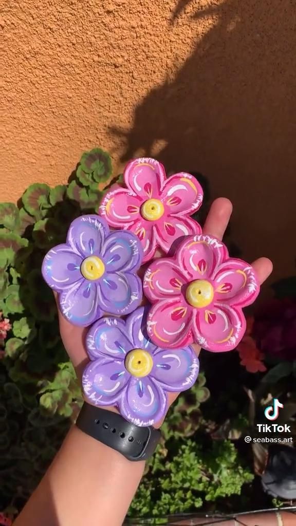 a hand holding some pretty flowers in it