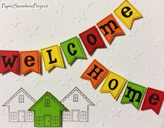 a welcome home card with colorful paper cutouts and the words welcome home on it