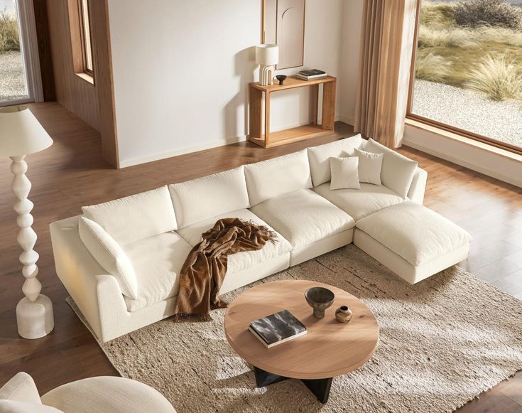 a living room with a large white sectional couch