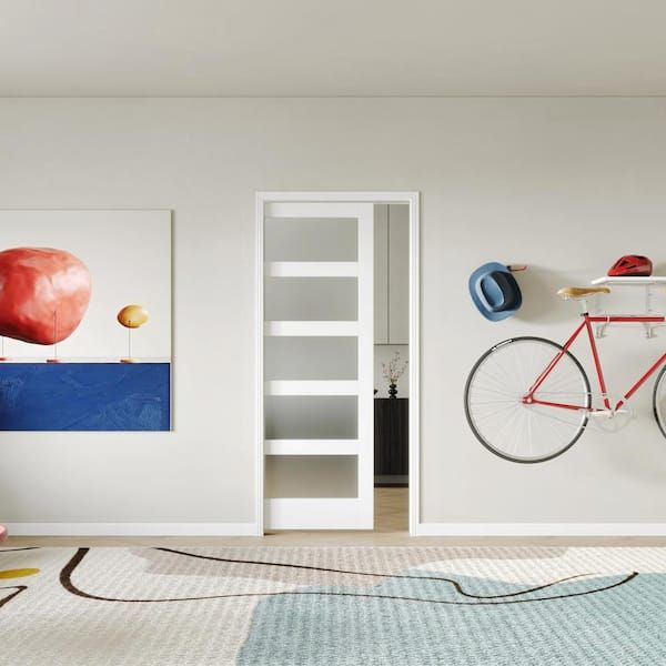 there is a bike hanging on the wall next to a book shelf and bookshelf