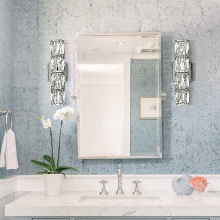 a bathroom with blue walls and white counter tops, two sinks and a large mirror on the wall