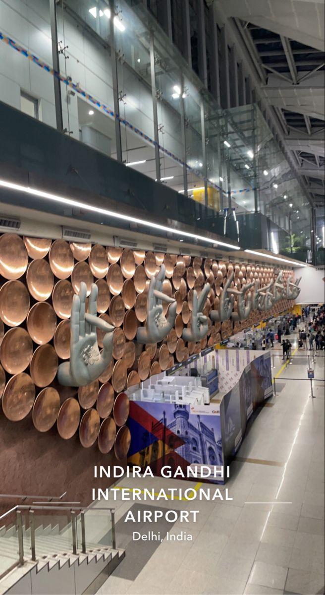 there are many copper pans hanging on the wall in this airport terminal lobby area