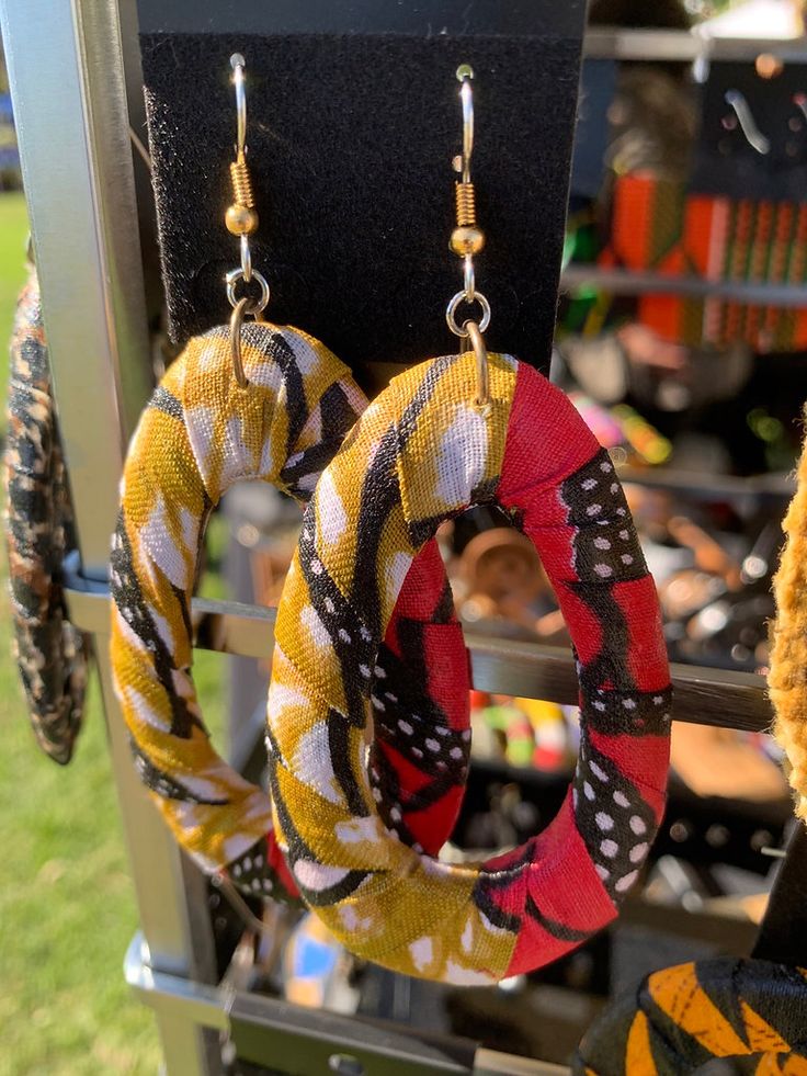 Make a bold statement with our stunning Ankara Earrings! These gorgeous earrings feature a unique combination of blue, red, and yellow Ankara print fabric wrapped around a wood base. Measuring 2 1/2 inches long, they are the perfect size to add a touch of flair to any outfit. Despite their bold appearance, these earrings are surprisingly lightweight and comfortable to wear all day long. Stand out from the crowd with our eye-catching Ankara Earrings Yellow Ankara, Ankara Earrings, Ankara Print, Red And Yellow, A Wood, Gorgeous Earrings, African Art, Print Fabric, Wrap Around