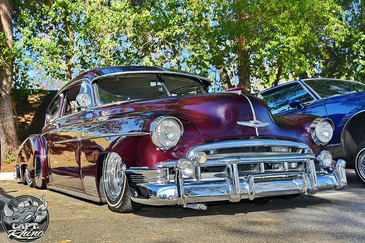 two classic cars parked next to each other