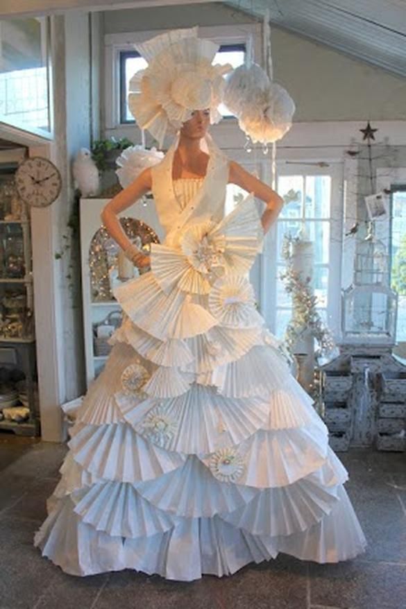 a woman in a white dress made out of paper