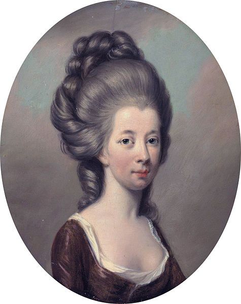 an oval portrait of a woman with braids in her hair, wearing a brown dress